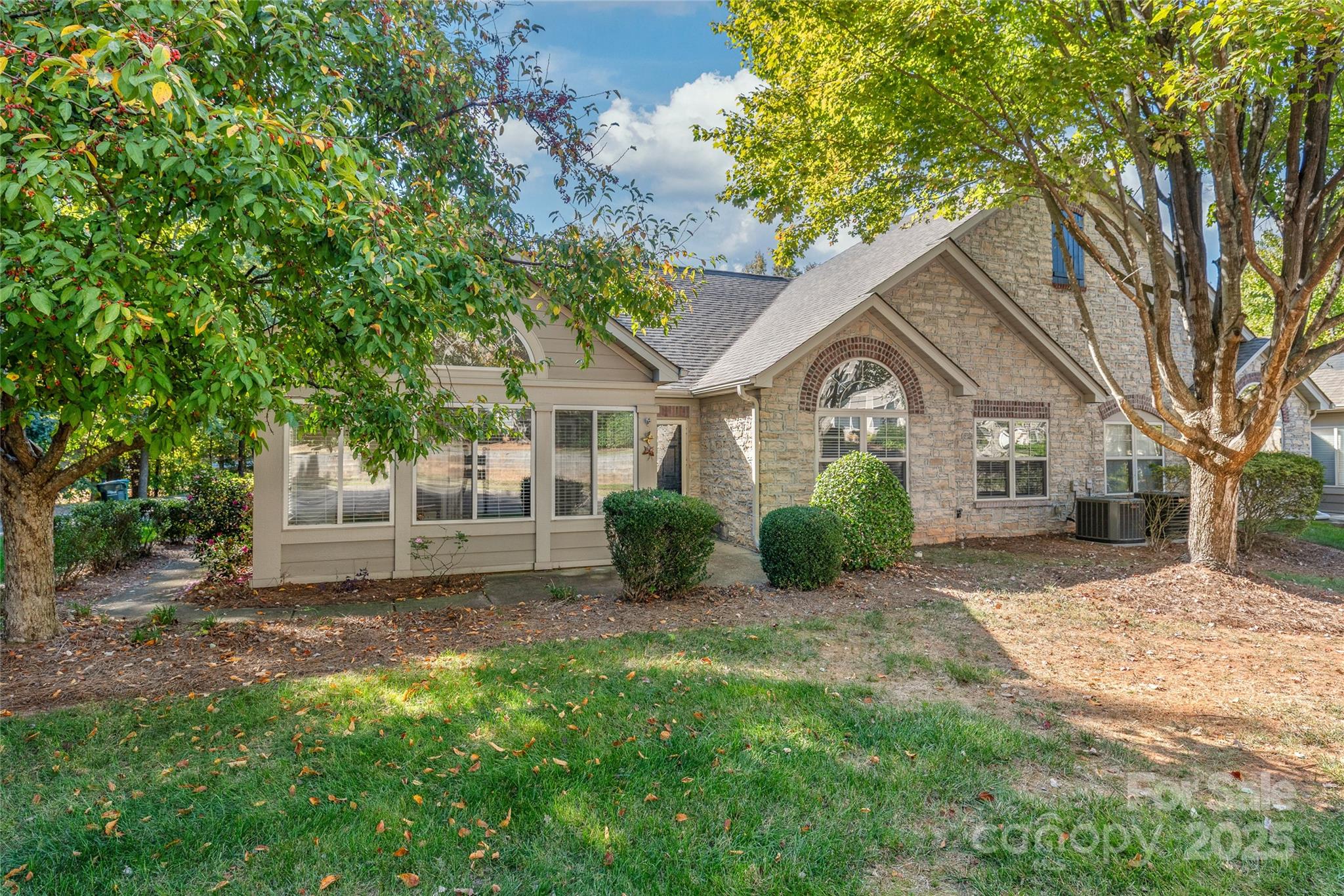 3052 Polo View Lane Matthews, NC 28105 - Photo 2 of 16 a view of a yard in front of a house with large windows