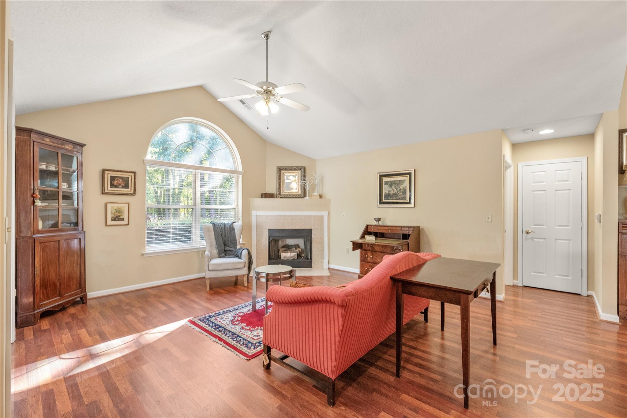 3052 Polo View Lane Matthews, NC 28105 - Photo 4 of 16 a living room with furniture a fireplace and a chandelier
