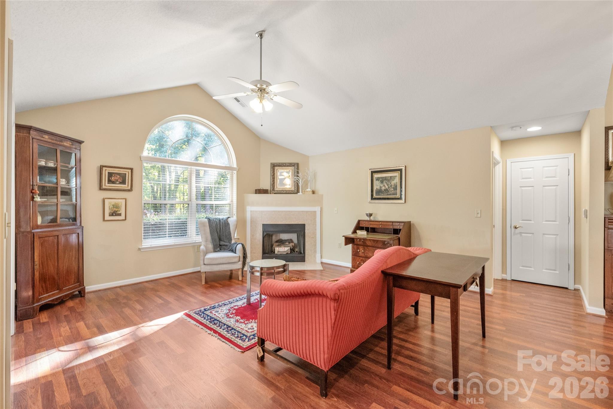 3052 Polo View Lane Matthews, NC 28105 - Photo 4 of 19 a living room with furniture a fireplace and a chandelier