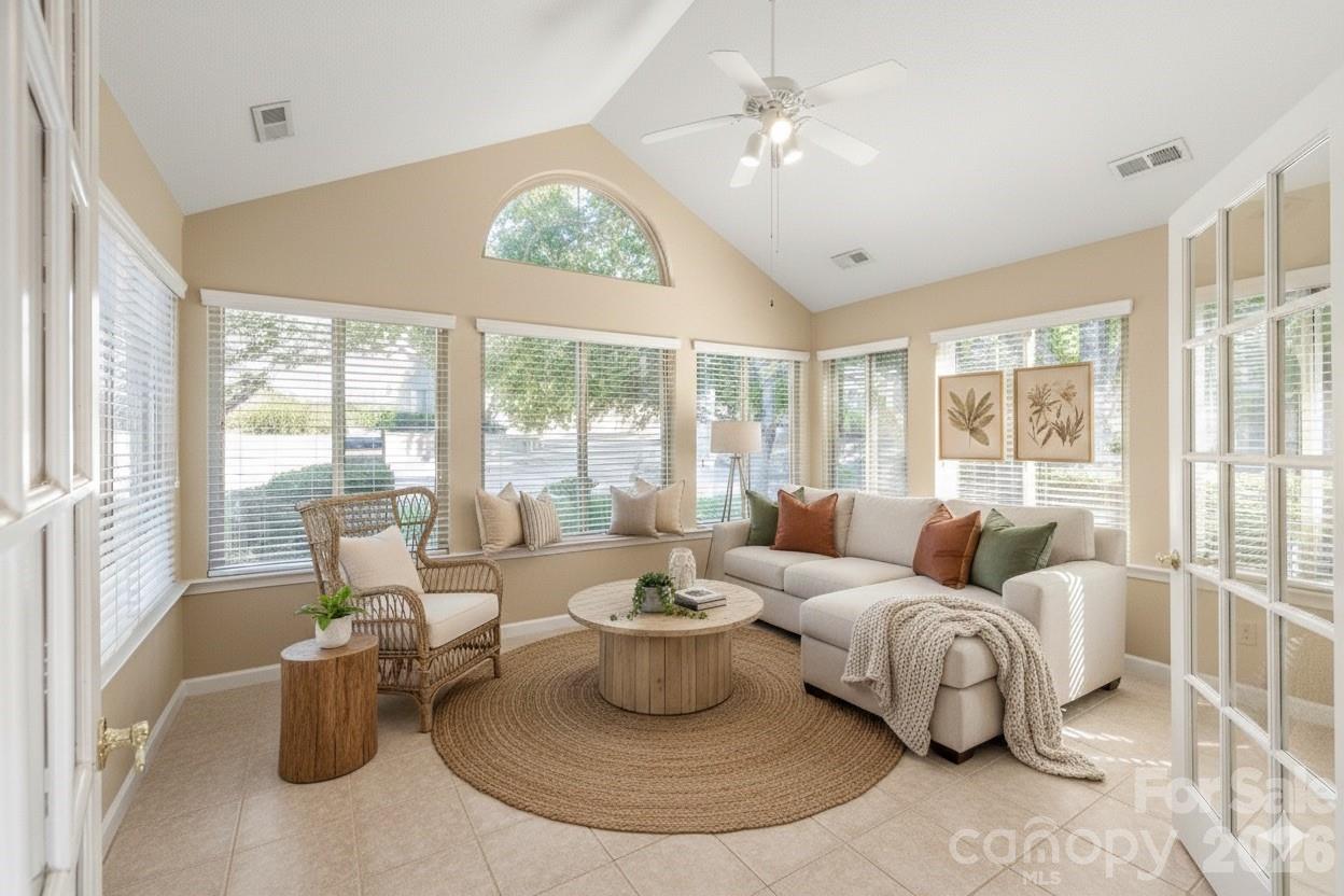 3052 Polo View Lane Matthews, NC 28105 - Photo 6 of 19 a living room with furniture a chandelier and a large window