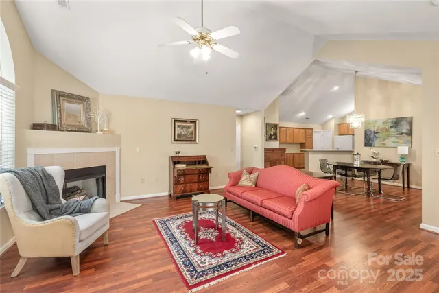 a living room with furniture a rug and a fireplace