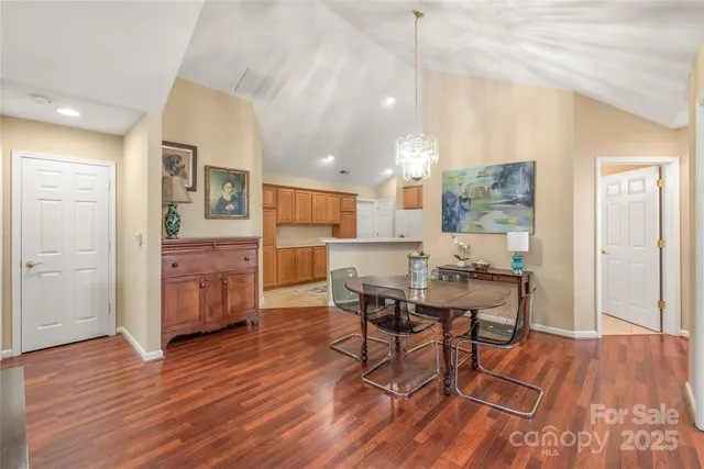 a dining room with furniture and wooden floor