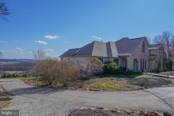 a bedroom with a bed and large windows