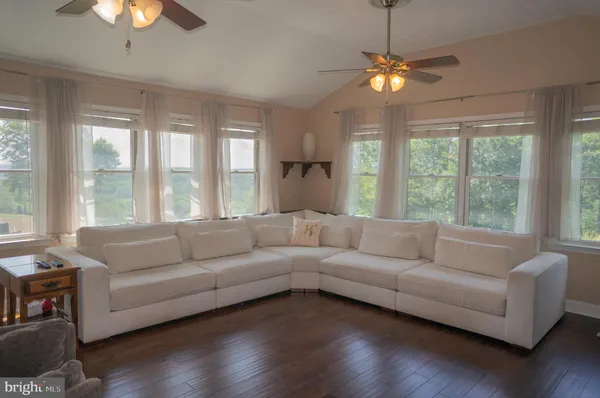 a room with table chairs and wooden floor