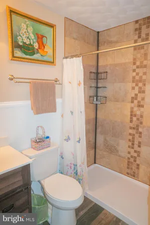 a view of a big house with a big yard and large trees