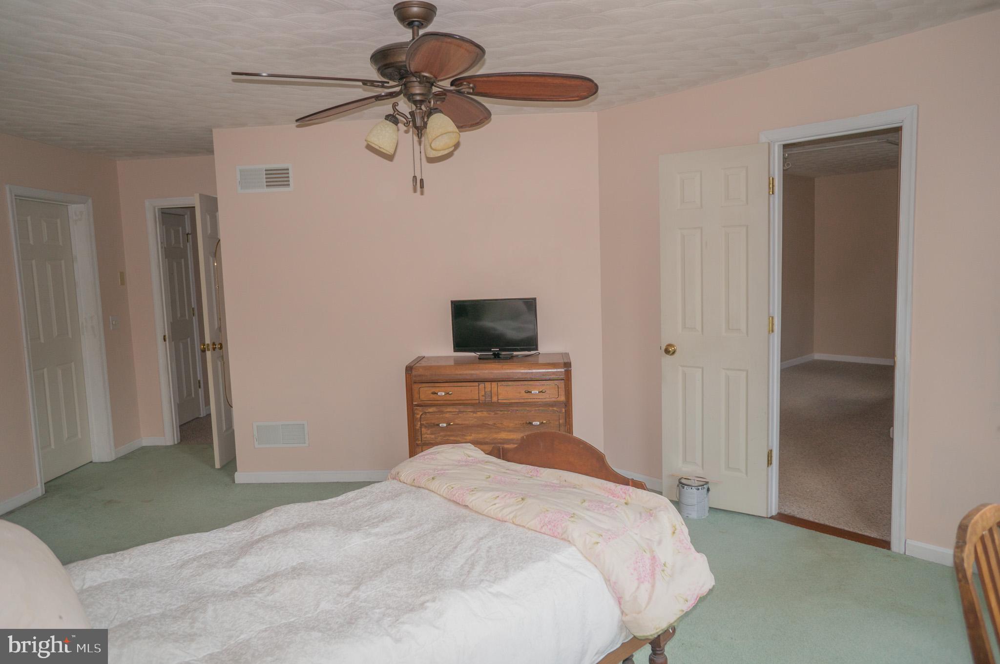 4815 Zeiglers Church Road Spring Grove, PA 17362 - Photo 59 of 122 a bedroom with a bed and a chandelier