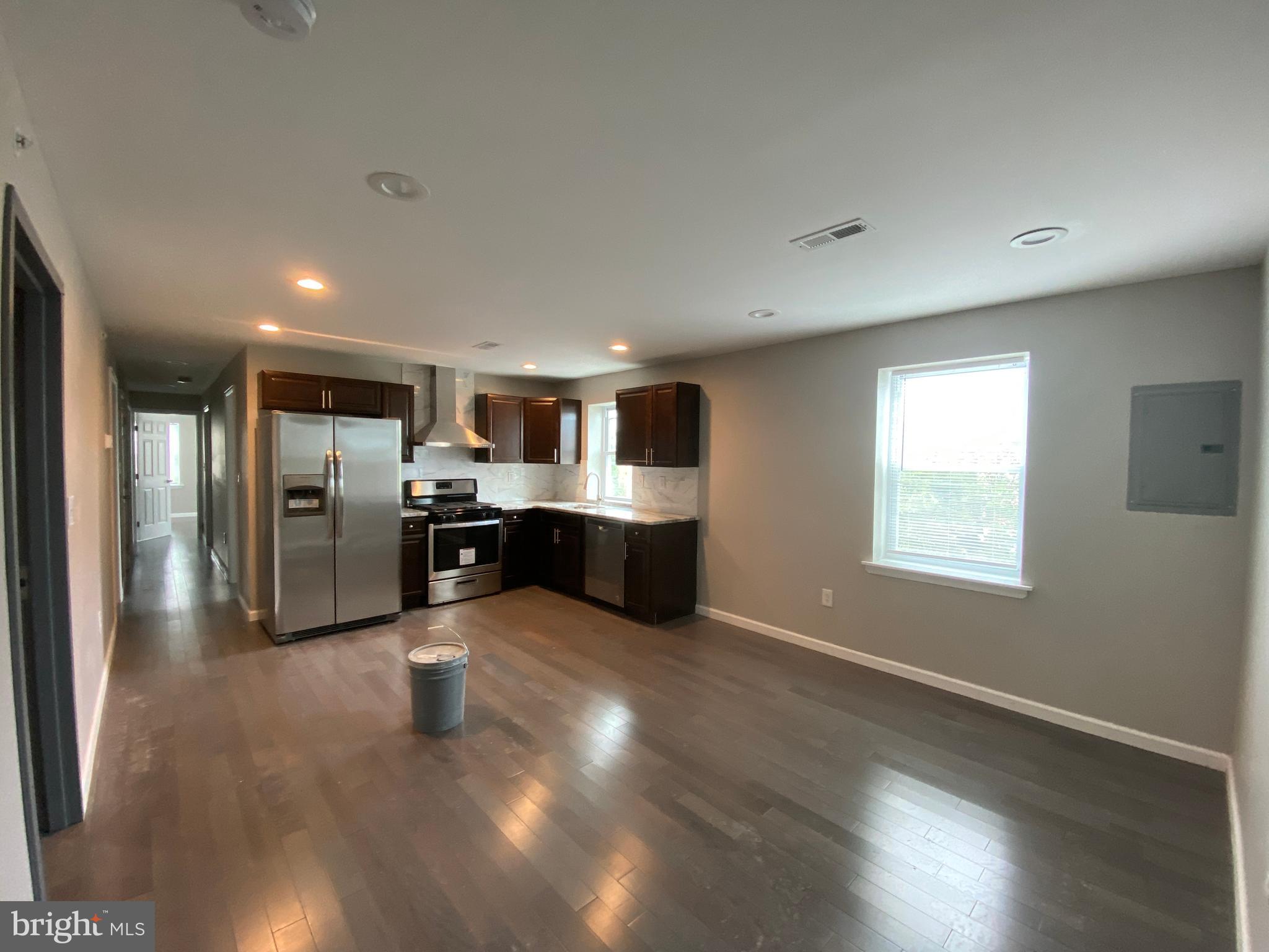 447 Diamond Street, Unit 2 Philadelphia, PA 19122 - Photo 3 of 18 a large kitchen with stainless steel appliances a large counter top