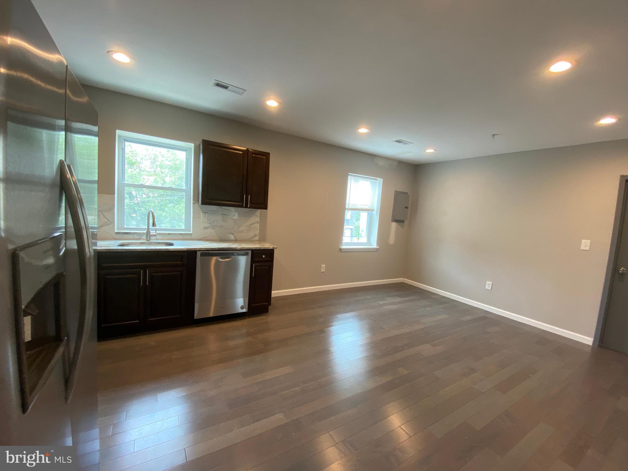 447 Diamond Street, Unit 2 Philadelphia, PA 19122 - Photo 5 of 18 a kitchen with stainless steel appliances a stove a sink a refrigerator and a window