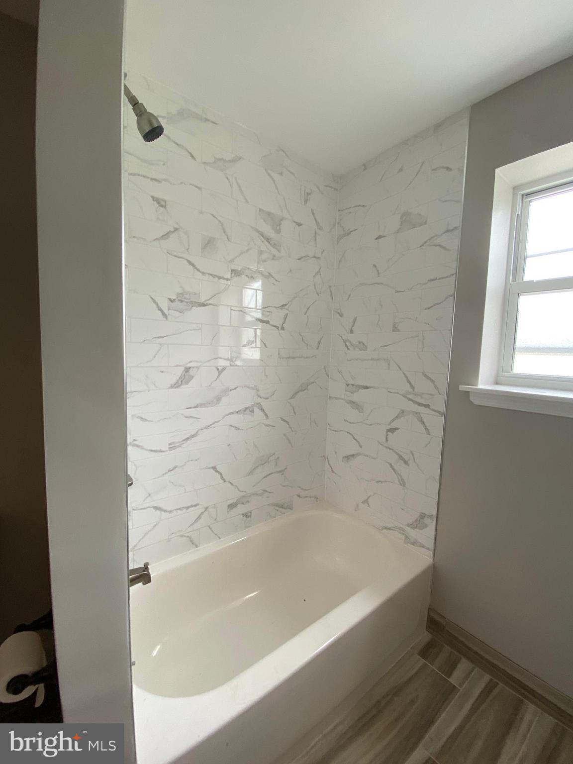 447 Diamond Street, Unit 2 Philadelphia, PA 19122 - Photo 10 of 18 a bath tub sitting next to a window