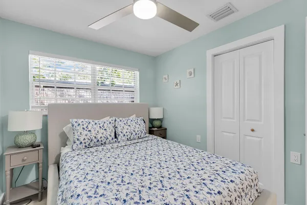 a bedroom with a large bed and a chandelier