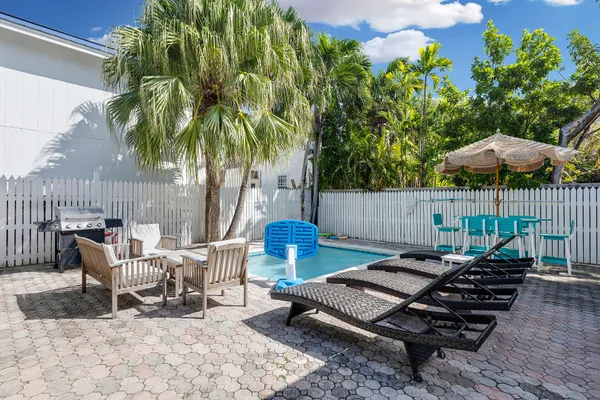 a view of a chairs and table in backyard