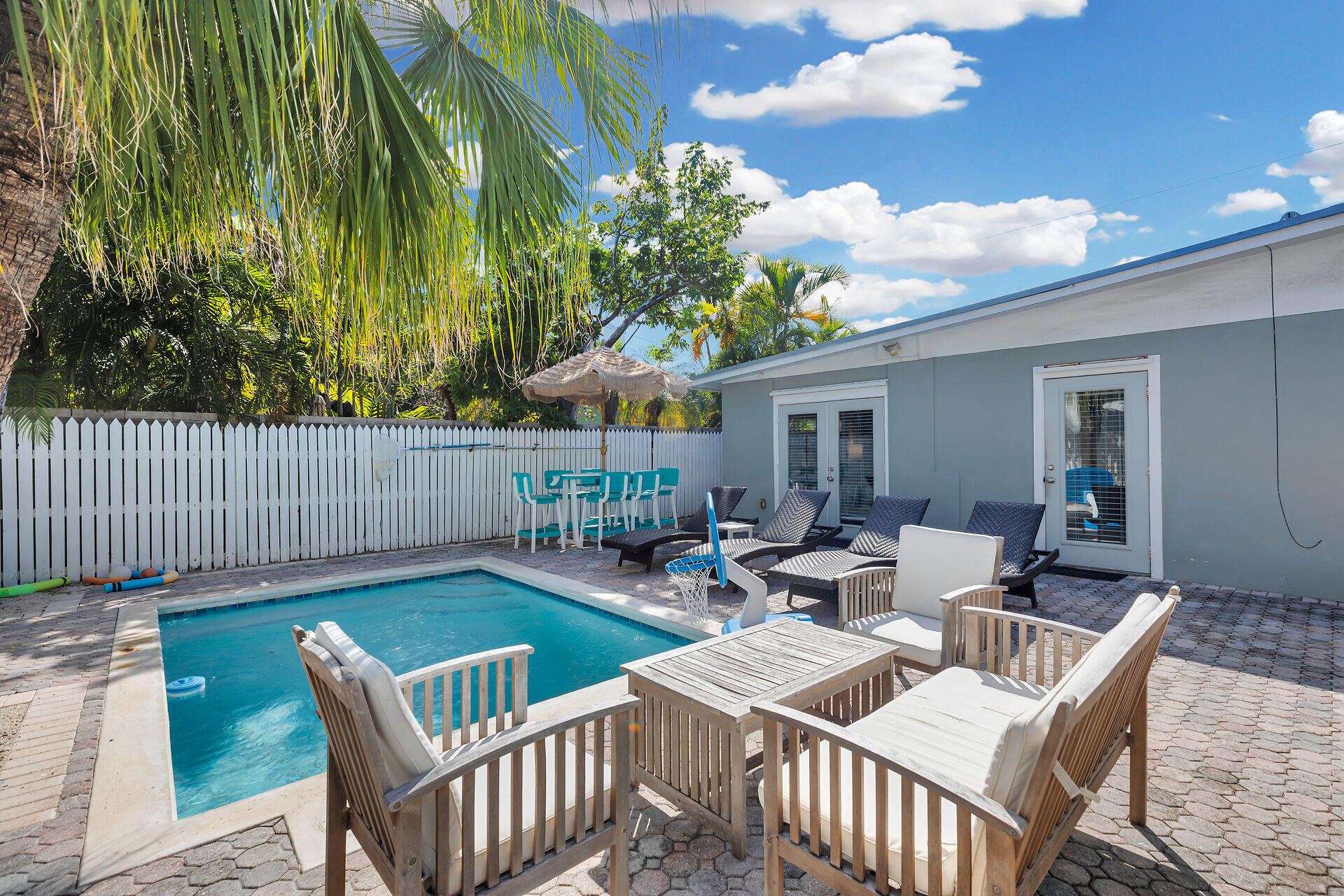 1707 George Street Key West, FL 33040 - Photo 25 of 39 a view of a patio with a dining table and chairs with wooden floor