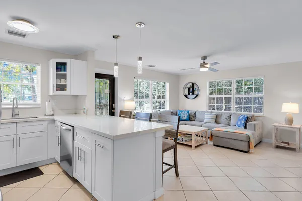 a large white kitchen with a stove a sink dishwasher and a refrigerator