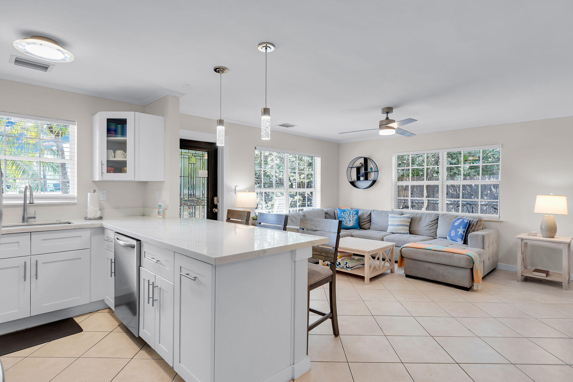 1707 George Street Key West, FL 33040 - Photo 8 of 39 a large white kitchen with a stove a sink dishwasher and a refrigerator