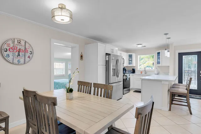 a view of a dining room with furniture and a chandelier