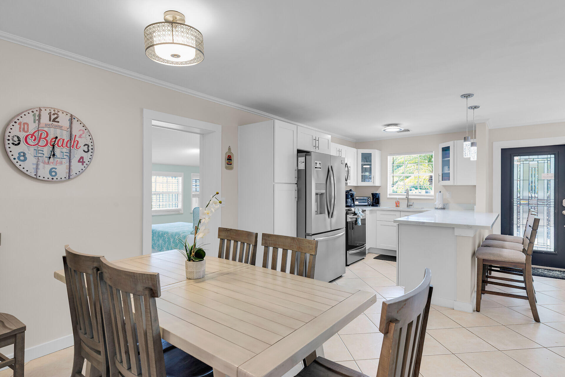 1707 George Street Key West, FL 33040 - Photo 9 of 39 a view of a dining room with furniture and a chandelier
