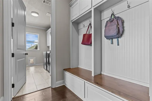 a hallway with a sink and a mirror