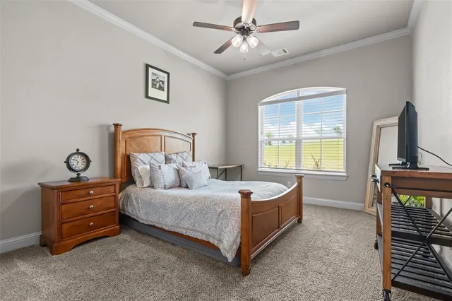 a bedroom with a bed dresser and a window