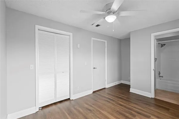 a view of an empty room with wooden floor