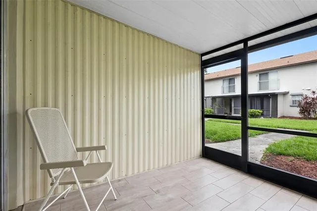a view of a porch with a chair and a gate