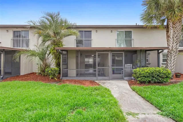 a front view of a house with a garden and plants