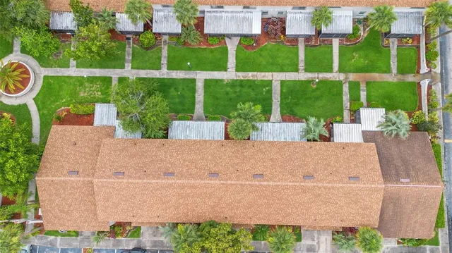 an aerial view of a house with swimming pool garden and outdoor seating