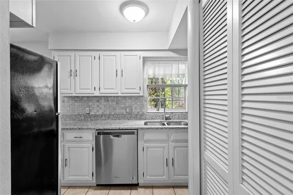 a kitchen with stainless steel appliances granite countertop a sink and a granite counter tops
