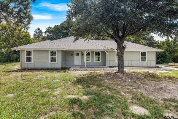 a house with huge green field in front of it