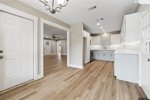 a view of a kitchen and kitchen with a wooden floor