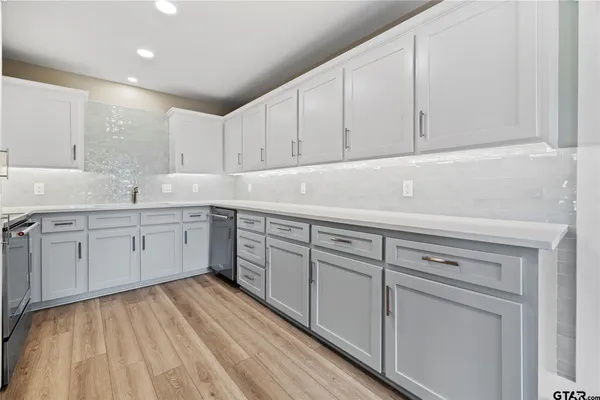 a kitchen with white cabinets sink and white appliances
