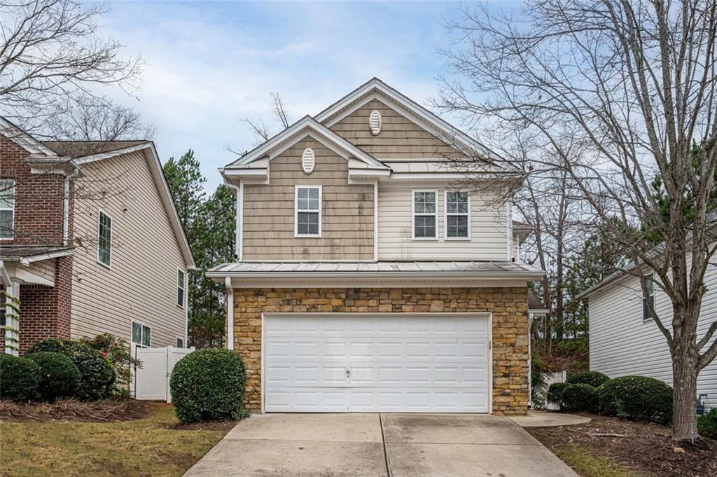 243 Silver Spring Street Dallas, GA 30157 - Photo 1 of 1 a front view of a house with a yard and garage