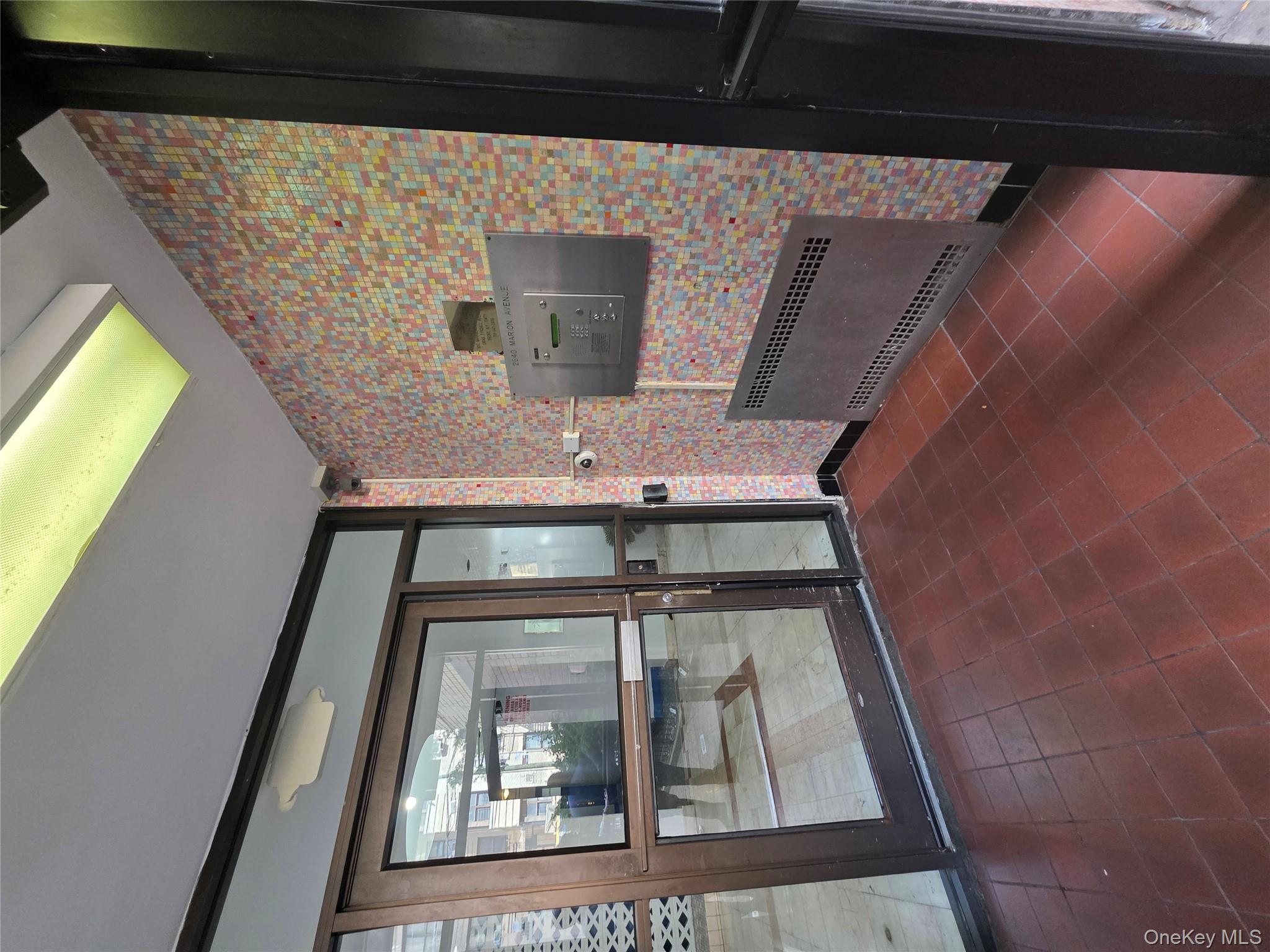 2640 Marion Avenue, Unit 6H Bronx, NY 10458 - Photo 2 of 14 a view of empty room with a fireplace and a flat screen tv