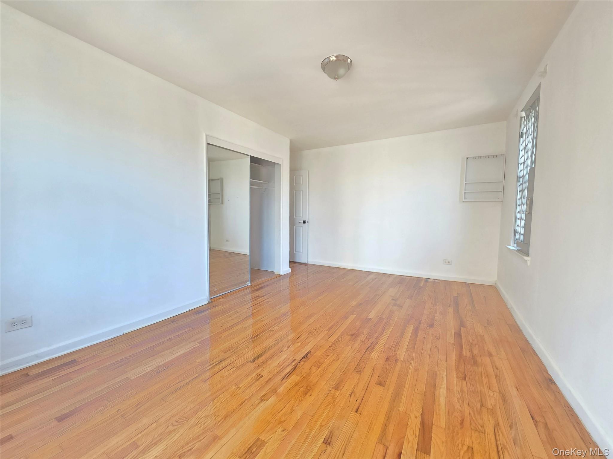 2640 Marion Avenue, Unit 6H Bronx, NY 10458 - Photo 4 of 14 a view of empty room with wooden floor