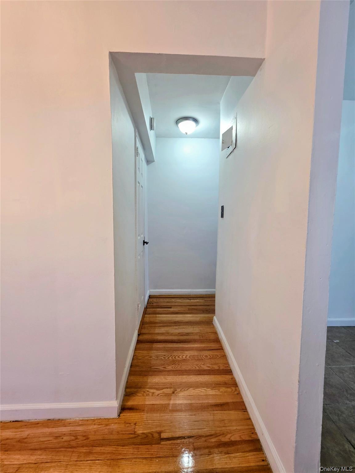 2640 Marion Avenue, Unit 6H Bronx, NY 10458 - Photo 5 of 14 a view of a hallway with wooden floor and staircase