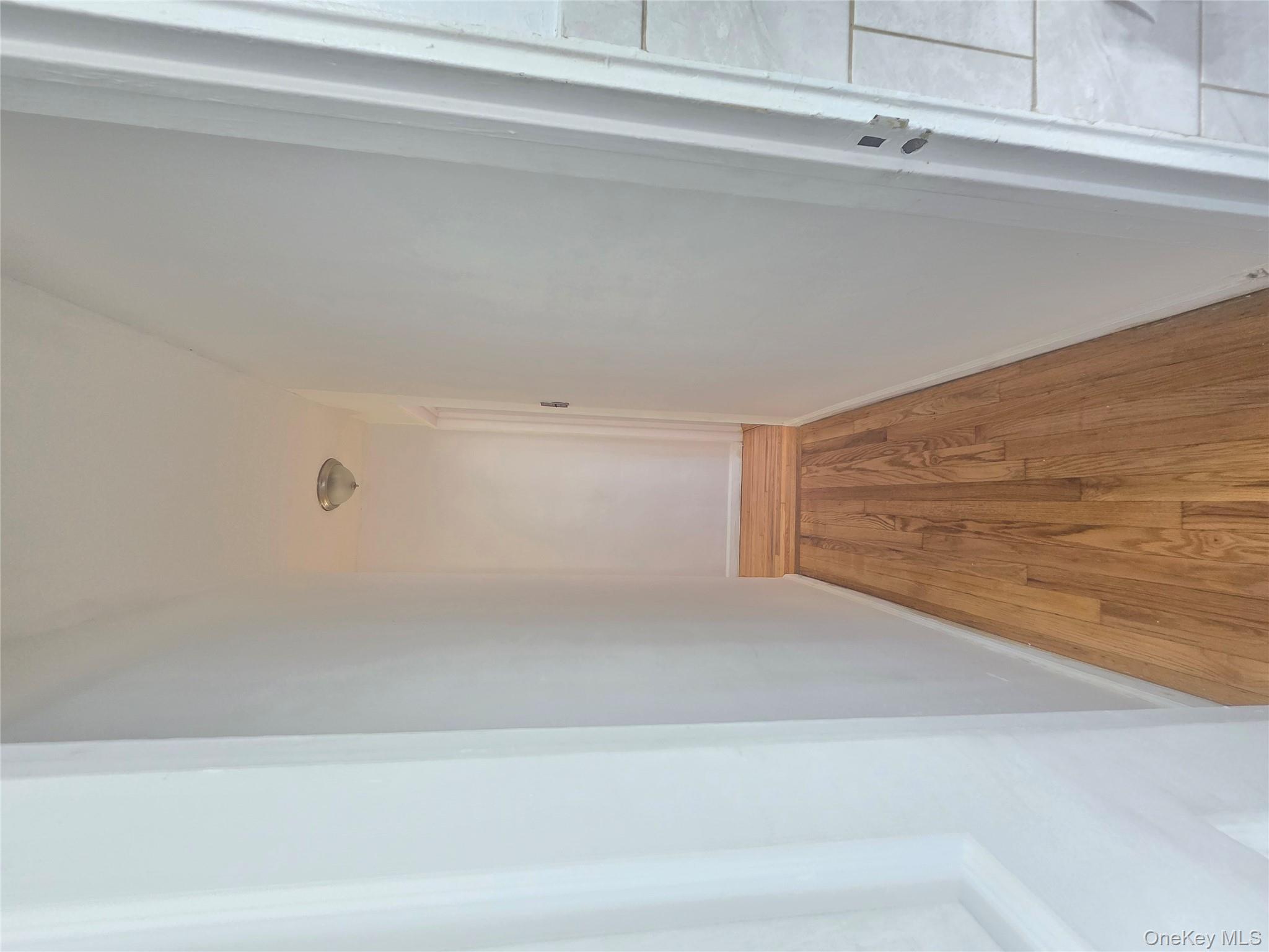 2640 Marion Avenue, Unit 6H Bronx, NY 10458 - Photo 10 of 14 a view of a hallway with wooden floor