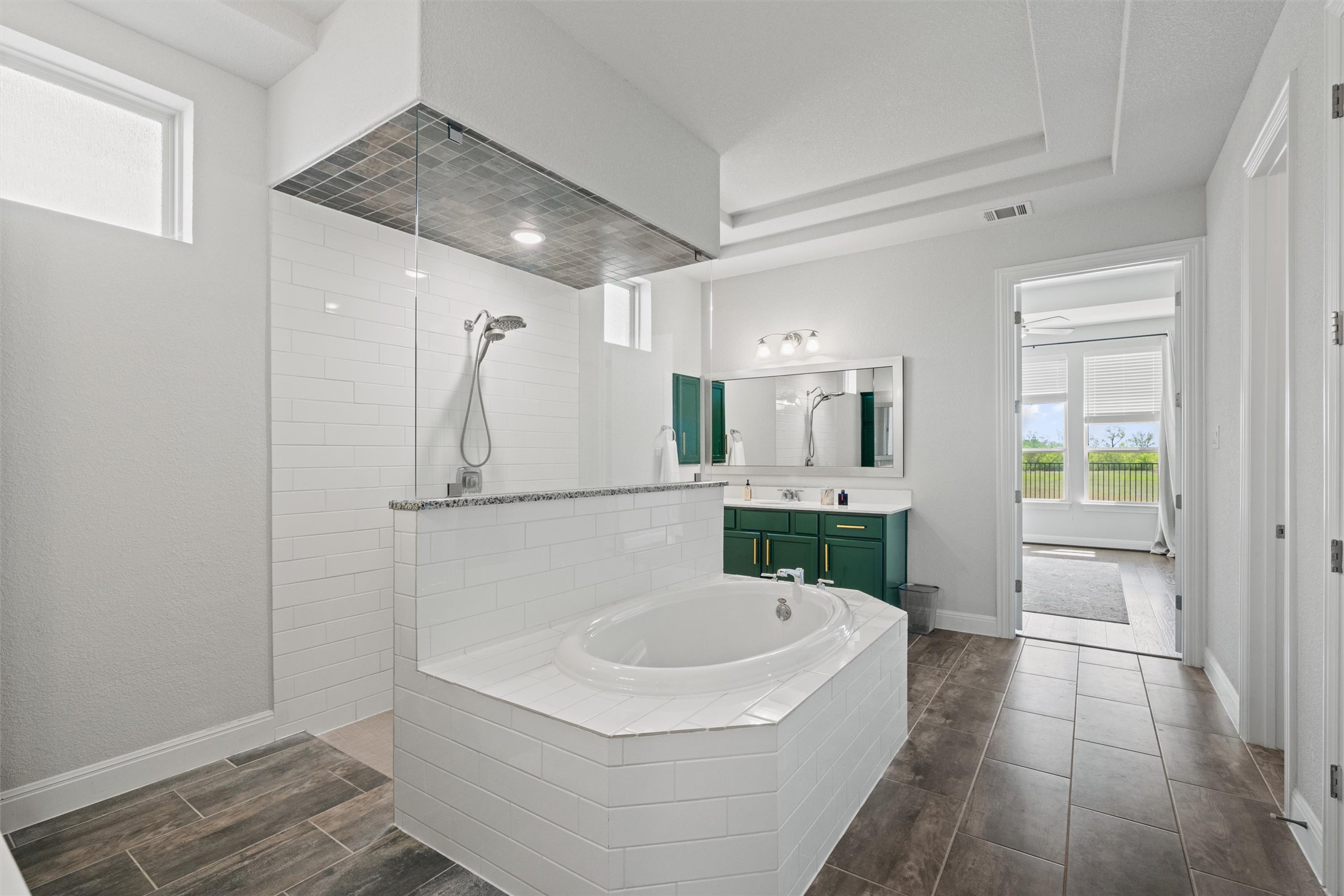 19325 Stembridge Run Pflugerville, TX 78660 - Photo 14 of 38 a bathroom with a sink a mirror and a bathtub
