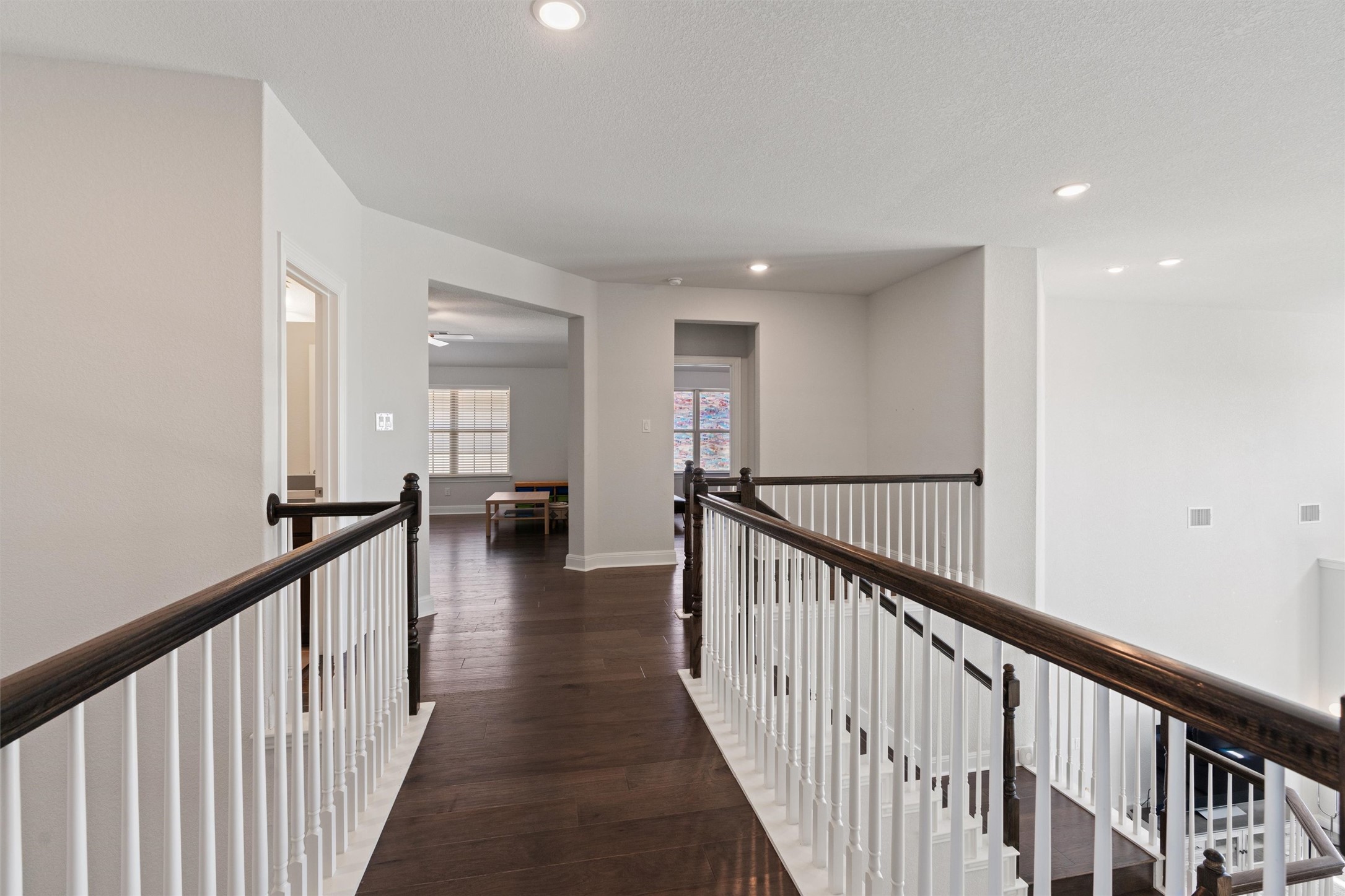 19325 Stembridge Run Pflugerville, TX 78660 - Photo 24 of 38 a view of a hallway with a large window and wooden floor