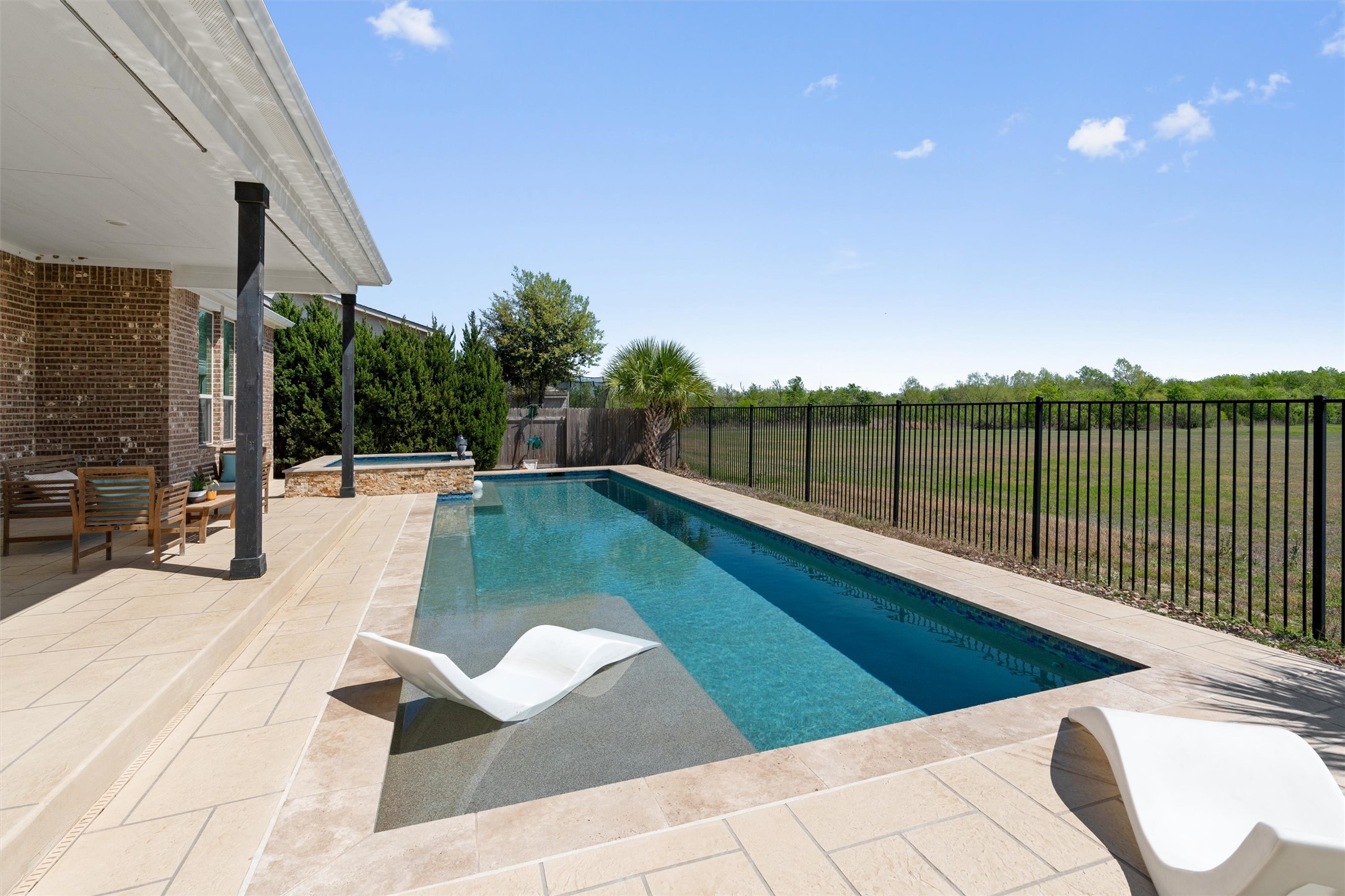 19325 Stembridge Run Pflugerville, TX 78660 - Photo 33 of 38 a view of a swimming pool with a patio and yard