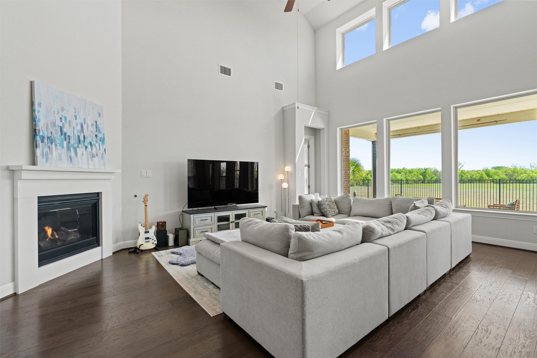 19325 Stembridge Run Pflugerville, TX 78660 - Photo 4 of 38 a living room with furniture a fireplace and a flat screen tv