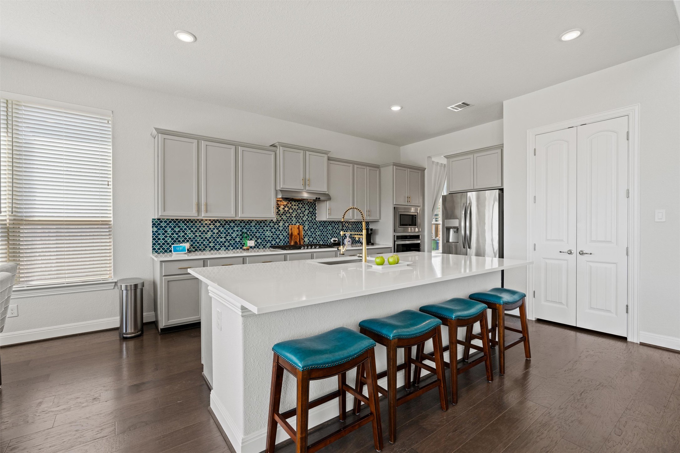 19325 Stembridge Run Pflugerville, TX 78660 - Photo 7 of 38 Kitchen featuring a kitchen bar, dark wood-style floors, a large island, stainless steel appliances, and recessed lighting