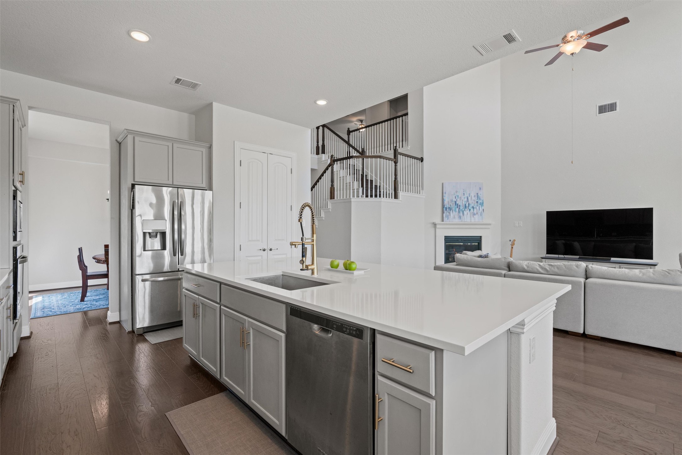 19325 Stembridge Run Pflugerville, TX 78660 - Photo 9 of 38 Kitchen with gray cabinets, stainless steel appliances, dark wood-style flooring, a kitchen island with sink, and recessed lighting