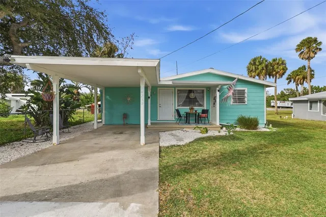 a view of a house with a porch and furniture