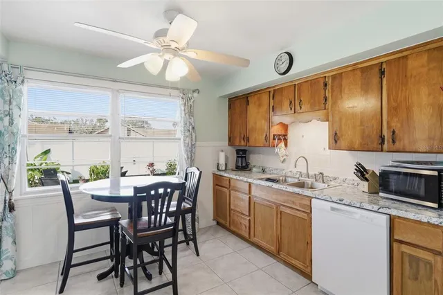 a kitchen with a table chairs sink and cabinets