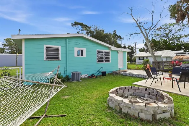 a backyard of a house with table and chairs