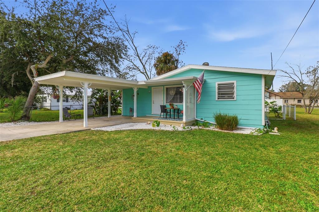 14235 Clamshell Lane Hudson, FL 34667 - Photo 3 of 25 a front view of a house with a yard