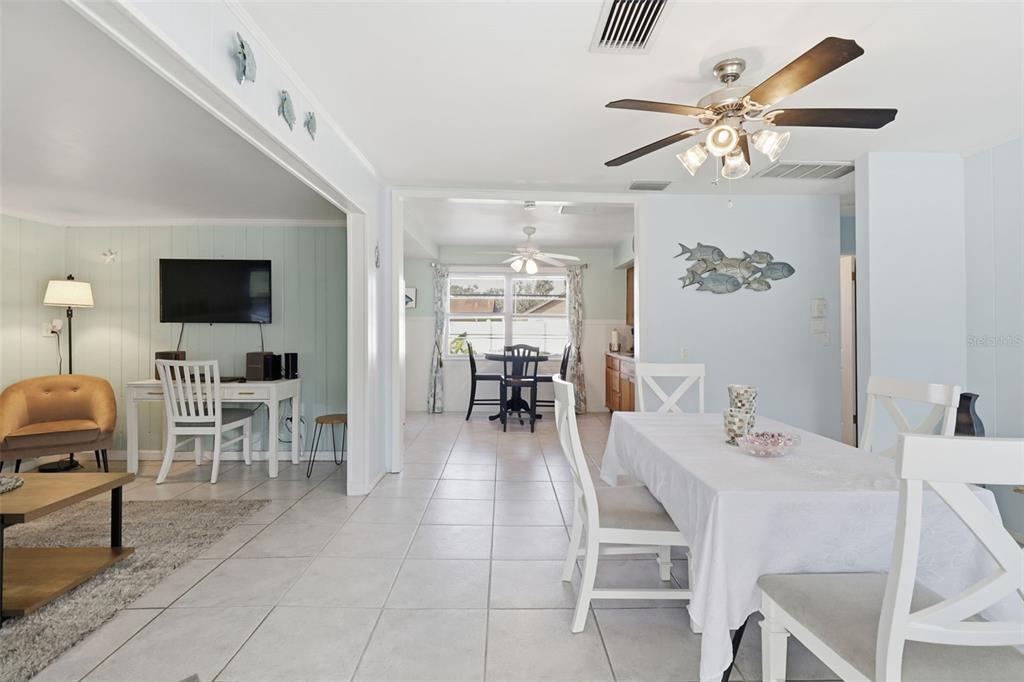 14235 Clamshell Lane Hudson, FL 34667 - Photo 6 of 25 a dining room with wooden floor a chandelier a wooden table and chairs