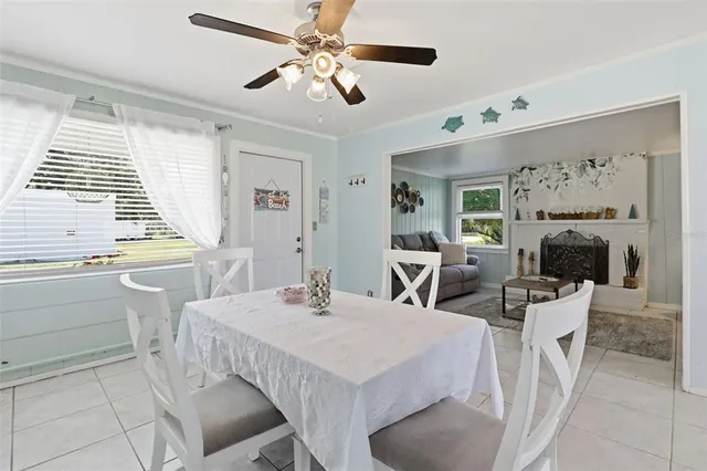 a view of a dining room with furniture and a large window