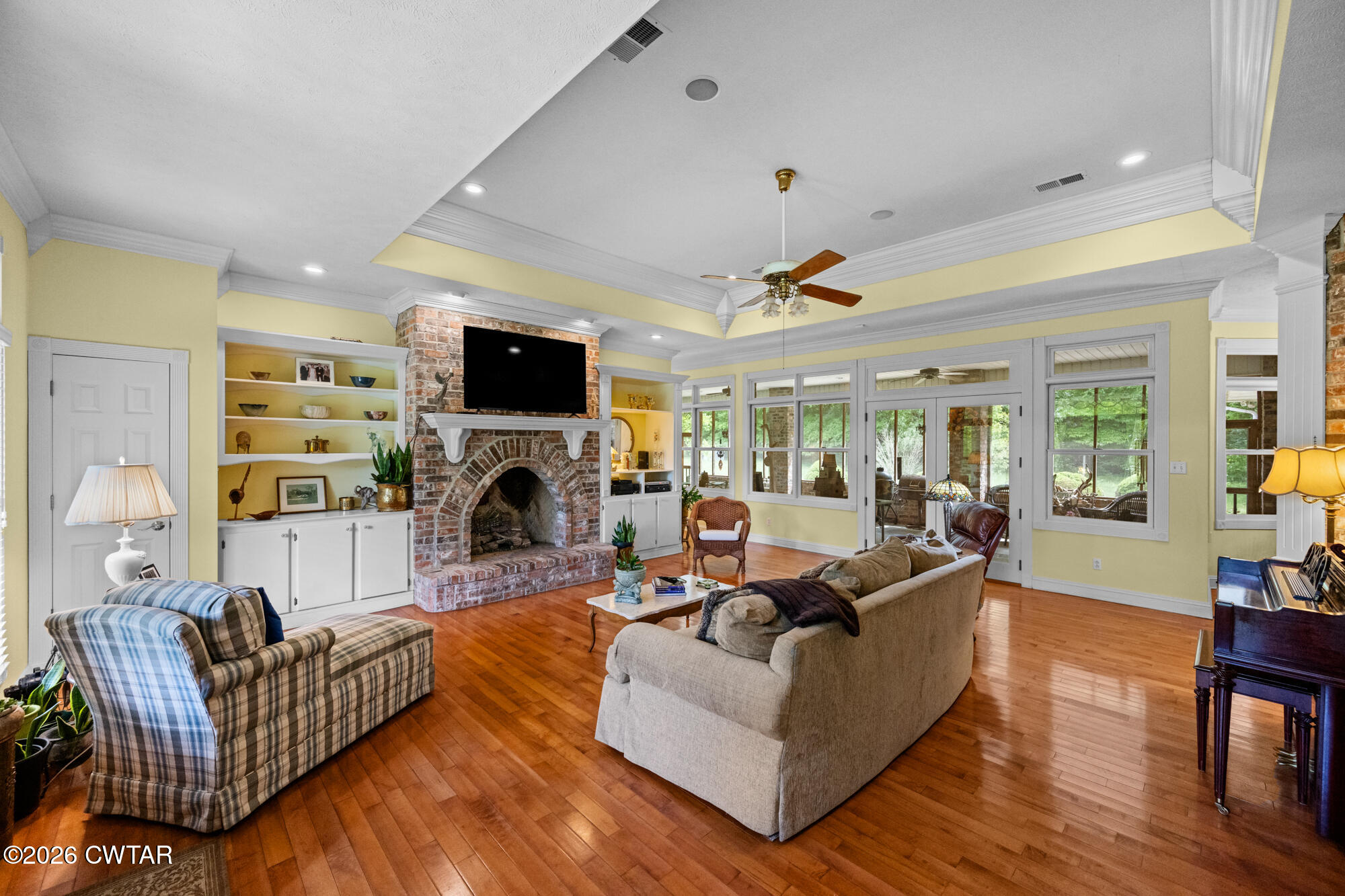 300 Harrison Road Dyersburg, TN 38024 - Photo 15 of 27 a living room with furniture a fireplace and a flat screen tv