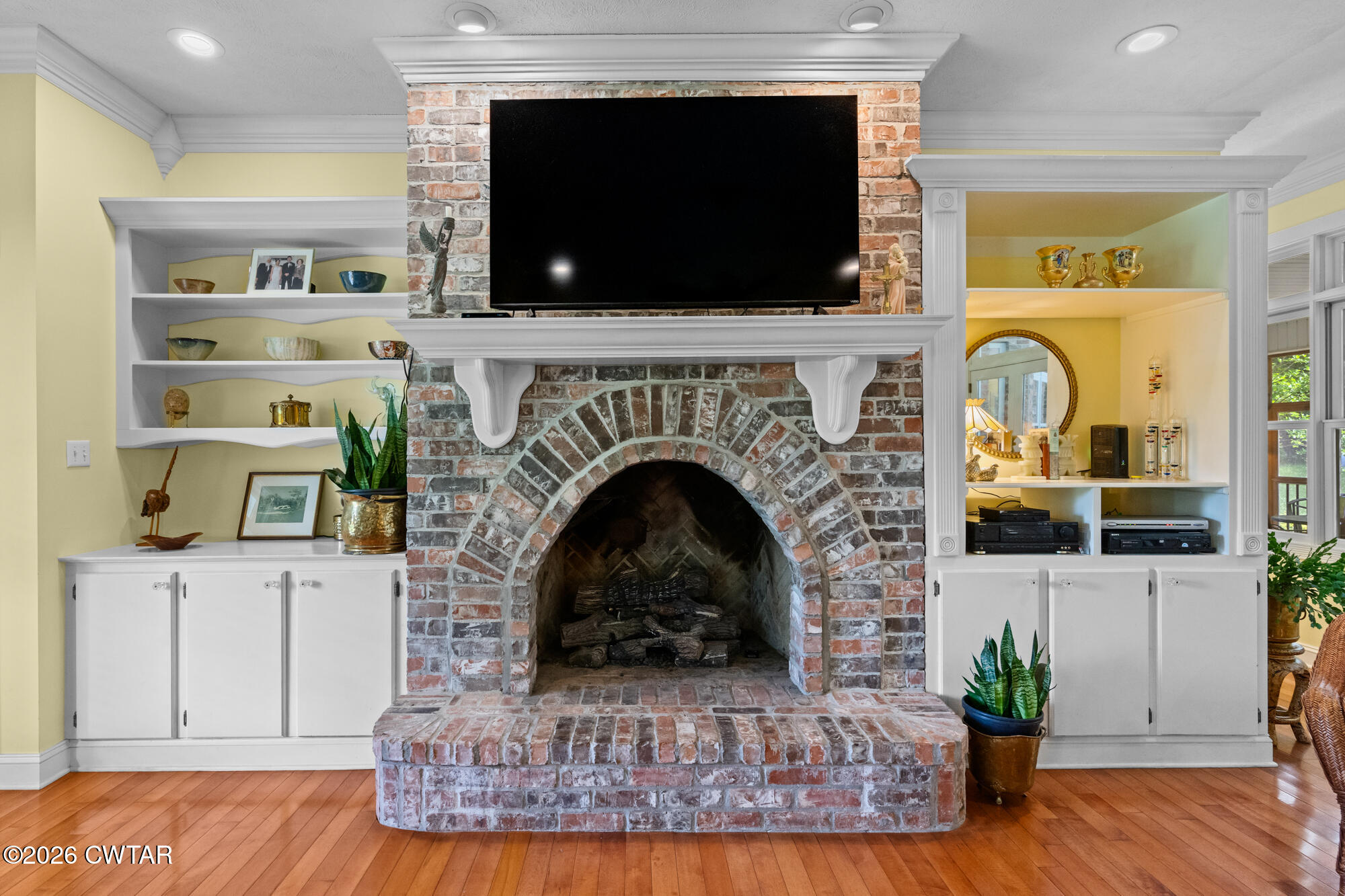 300 Harrison Road Dyersburg, TN 38024 - Photo 16 of 27 a living room with furniture a flat screen tv and a fireplace