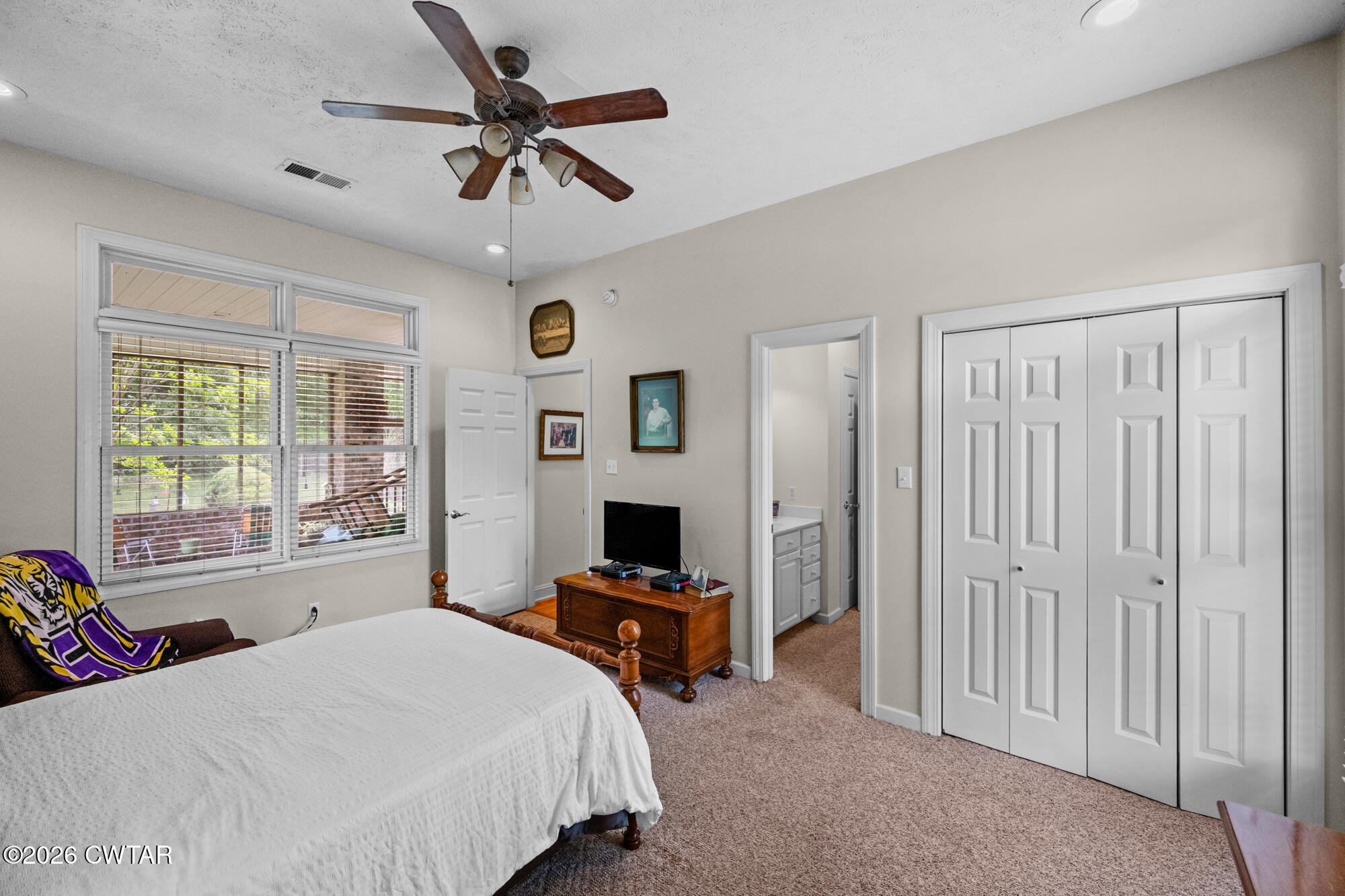 300 Harrison Road Dyersburg, TN 38024 - Photo 19 of 27 a bedroom with a bed and a chandelier